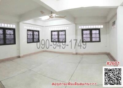 Spacious empty living room with large windows and tiled flooring