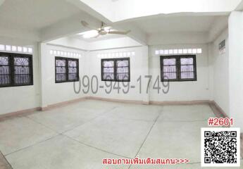 Spacious empty living room with large windows and tiled flooring