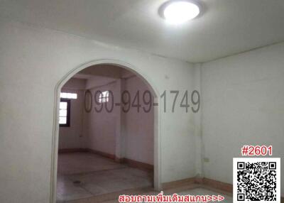 Spacious unfurnished room with arched doorway and tiled flooring