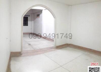 Spacious empty interior of a building with arched doorways and tiled flooring