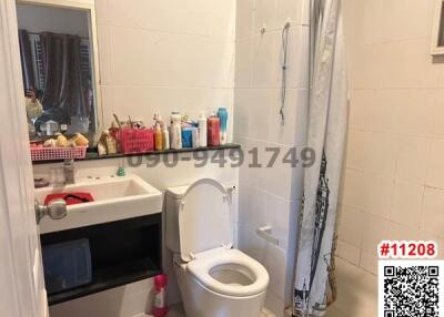 Bright bathroom with a toilet and shower curtain