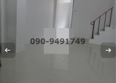 Spacious and bright unfurnished interior space of a building with glossy floor and staircase