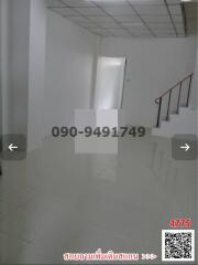 Spacious and bright unfurnished interior space of a building with glossy floor and staircase