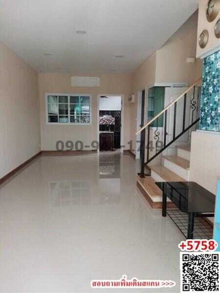 Spacious indoor area with staircase and tiled flooring