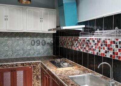 Contemporary kitchen with granite countertops and checkered tile backsplash