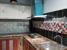 Contemporary kitchen with granite countertops and checkered tile backsplash