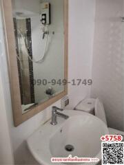 Compact bathroom with white fixtures and a glass shower partition