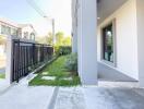 Modern house exterior with a well-maintained pathway and green landscaping