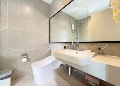Modern bathroom with wall-mounted sink and mirror