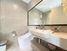 Modern bathroom with wall-mounted sink and mirror