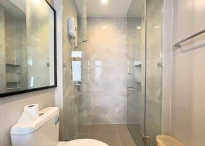 Modern bathroom interior with glass shower and white ceramics