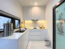 Modern kitchen with stainless steel appliances and white cabinetry