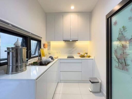 Modern kitchen with stainless steel appliances and white cabinetry