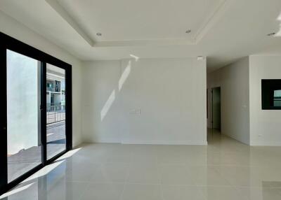 Spacious and well-lit empty living room with large windows