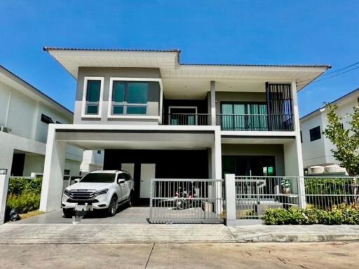 Modern two-story house with spacious driveway and balcony