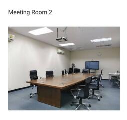 Spacious Meeting Room with Conference Table and Chairs