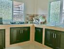 Bright kitchen with tile flooring and mosaic window details