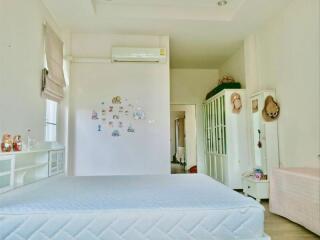 Spacious and well-lit bedroom with modern amenities