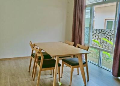 Bright dining area with wooden table and chairs