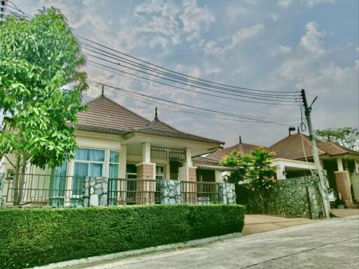 Suburban house with stone accents and lush greenery