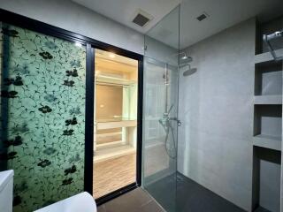 Modern bathroom with walk-in shower and decorative glass partition