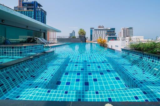 Sparkling community swimming pool with city view