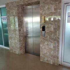 Modern elevator entrance in a building lobby with marble walls