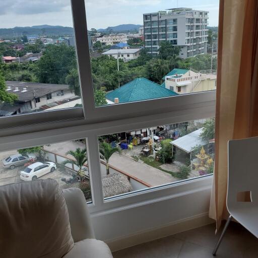 Urban view from high-rise building window with partial interior view