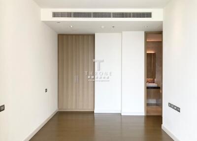 Spacious and modern empty room with wooden door and white walls