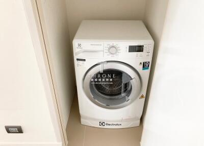 Modern Electrolux washing machine in a tidy laundry space