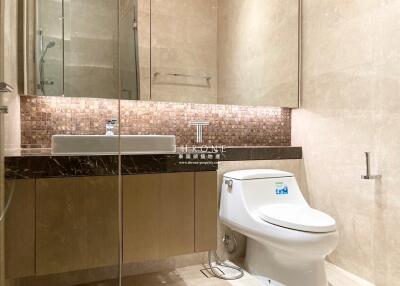 Modern bathroom with earth tone tiles and upscale fixtures