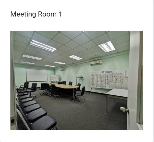 Spacious meeting room with conference table and office chairs