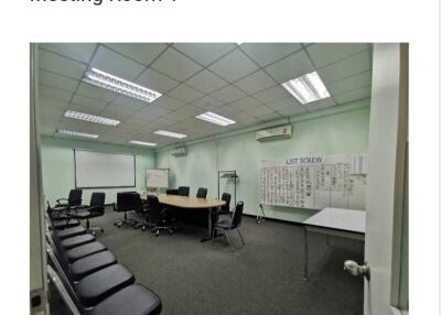 Spacious meeting room with conference table and office chairs