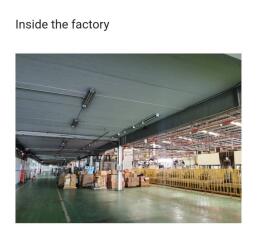 Interior of a spacious factory with organized goods and industrial lighting
