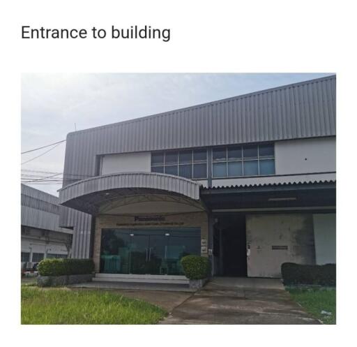 Entrance to modern industrial building with metal roofing