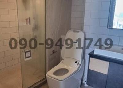 Modern bathroom with a glass shower enclosure and toilet