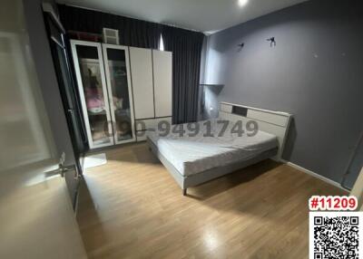 Modern bedroom with laminate flooring and minimalist furniture