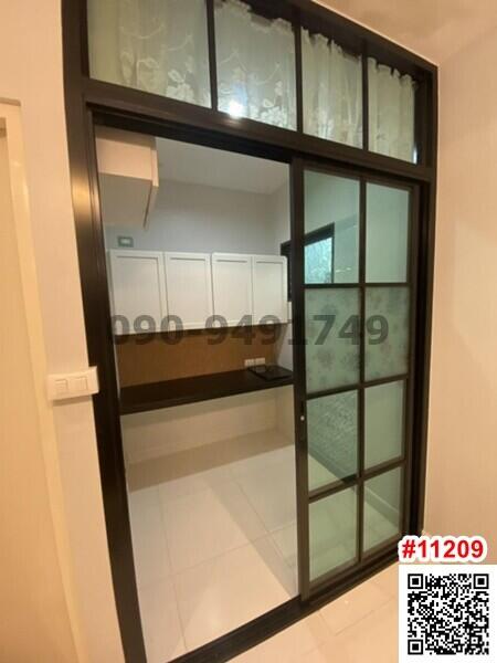 Modern entryway with glass door and built-in cabinets