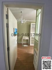 View of a home entrance leading to a well-lit room with classic decor