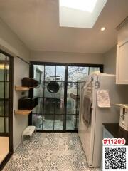 Compact kitchen space with skylight and laundry area
