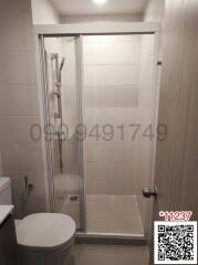 Modern bathroom with glass shower and white tiles