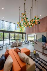 Modern lobby interior with colorful art installation, comfortable seating, and high ceiling