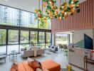 Modern lobby interior with colorful art installation, comfortable seating, and high ceiling