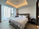 Modern bedroom interior with king-sized bed and city view