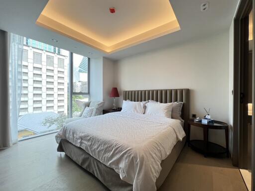 Modern bedroom interior with king-sized bed and city view