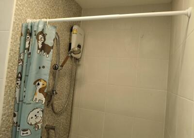 Compact bathroom with a shower and playful curtain