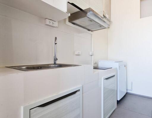 Modern kitchen with white cabinetry and appliances