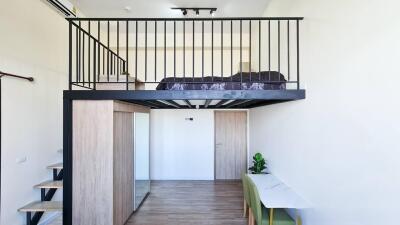 Modern loft style bedroom with elevated sleeping area