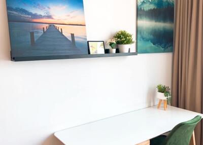 Cozy dining area with white table and modern artwork