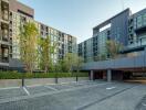 Modern apartment complex exterior with parking facility